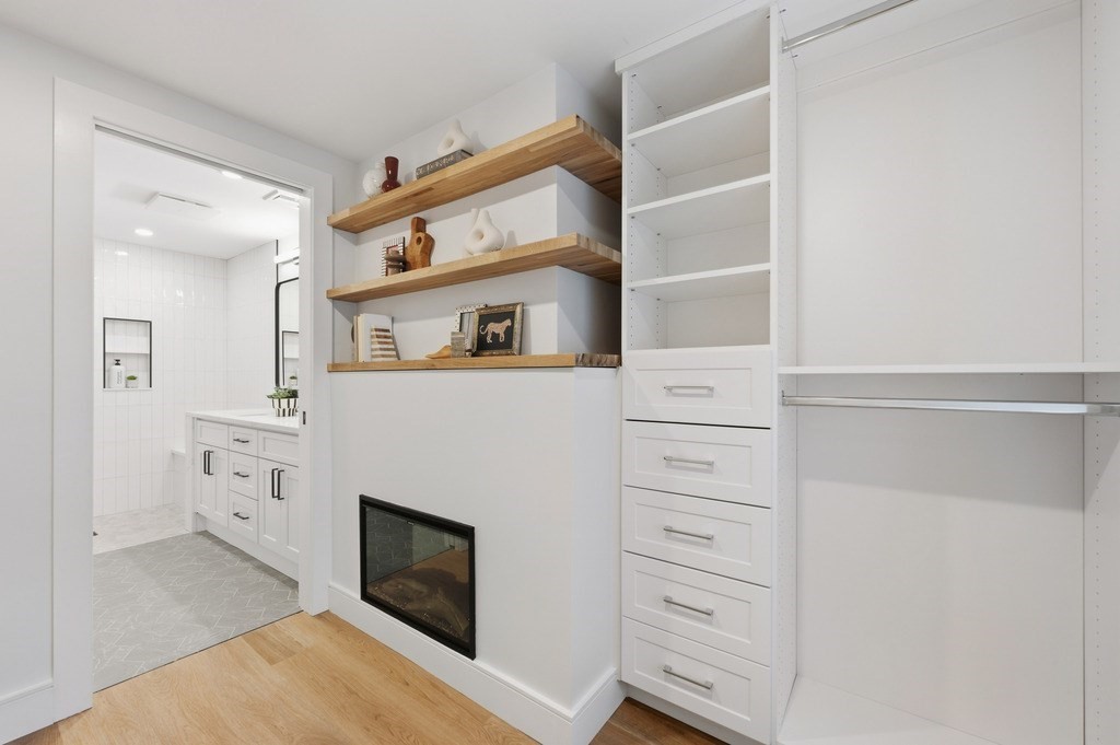 94 St Botolph Street, Unit 1 Boston, MA 02116 - Photo 29 of 37 a living room with cabinets and a fireplace
