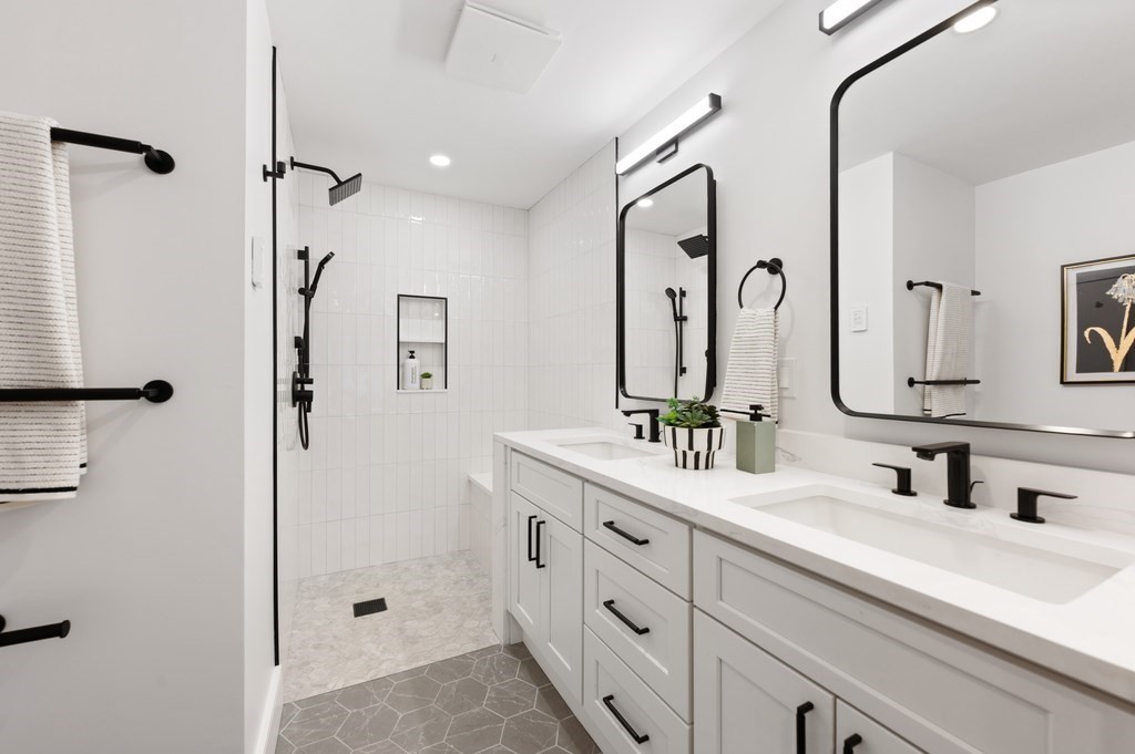 94 St Botolph Street, Unit 1 Boston, MA 02116 - Photo 30 of 37 a bathroom with double vanity sink a mirror and shower
