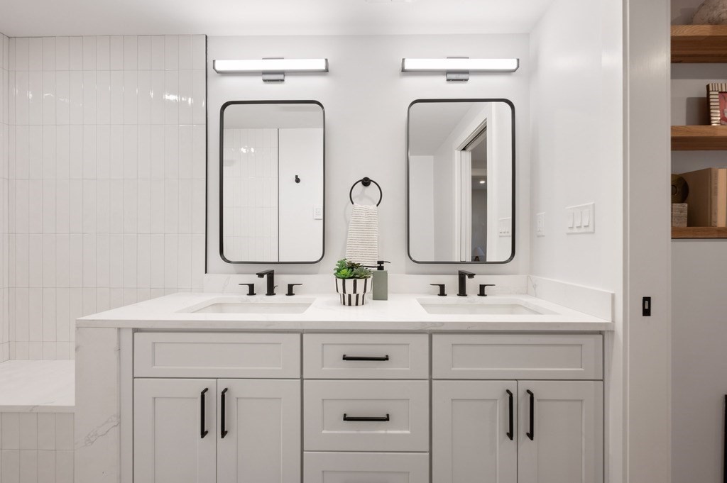 94 St Botolph Street, Unit 1 Boston, MA 02116 - Photo 32 of 37 a bathroom with double vanity sinks and two mirror