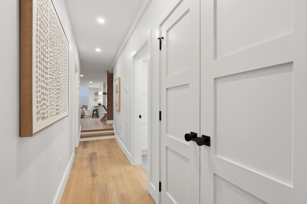 94 St Botolph Street, Unit 1 Boston, MA 02116 - Photo 33 of 37 a view of a hallway with wooden floor and staircase