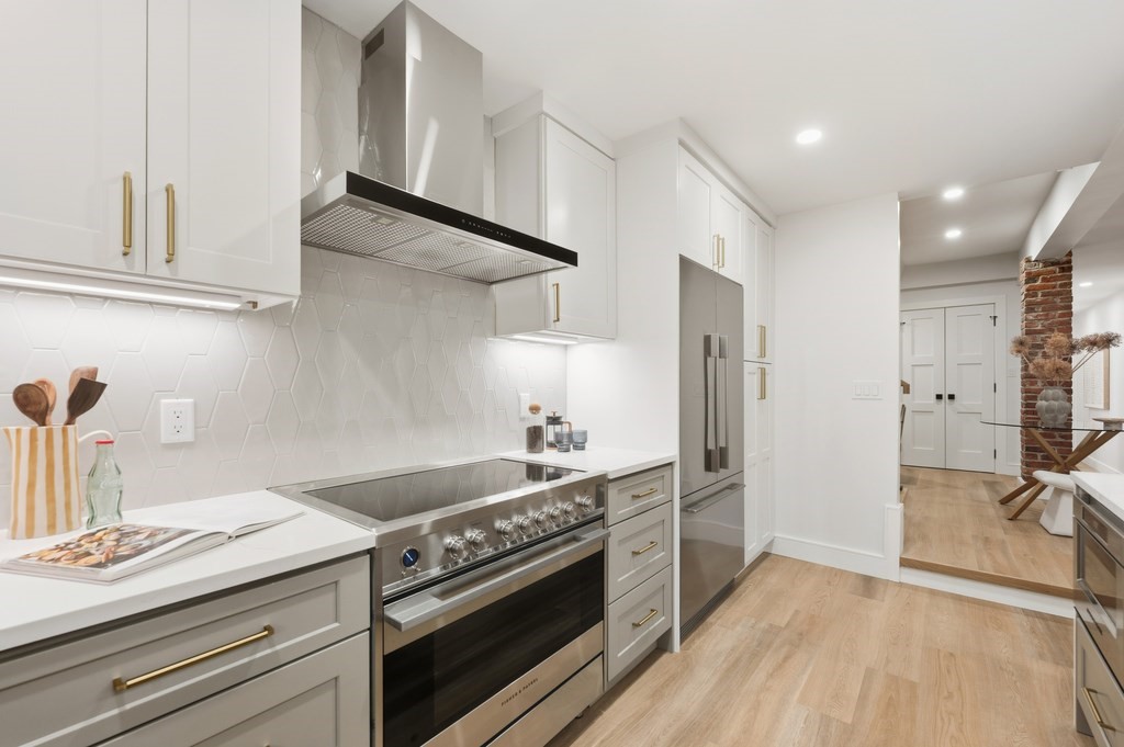 94 St Botolph Street, Unit 1 Boston, MA 02116 - Photo 7 of 37 a kitchen with stainless steel appliances granite countertop a stove and a refrigerator