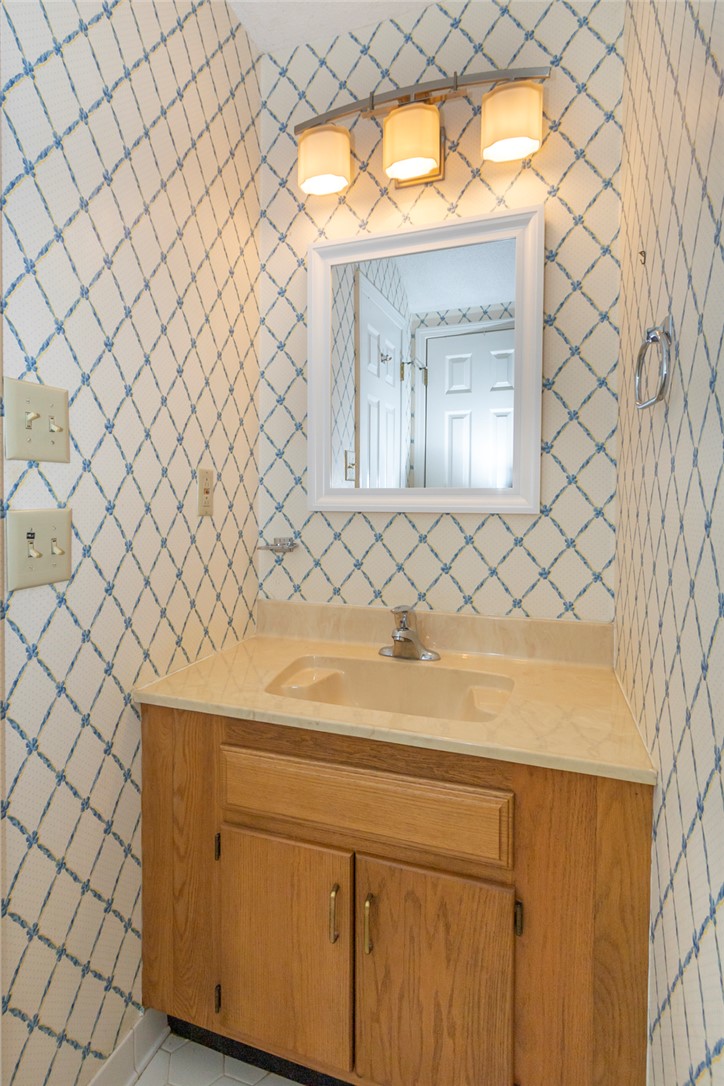 1302 Leeward Road Anderson, SC 29625 - Photo 21 of 50 A compact vanity with an integrated sink and light wood cabinetry is complemented by a mirrored medicine cabinet.
