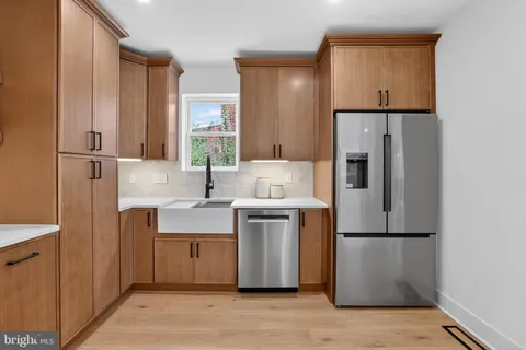 a kitchen with kitchen island a sink appliances and cabinets