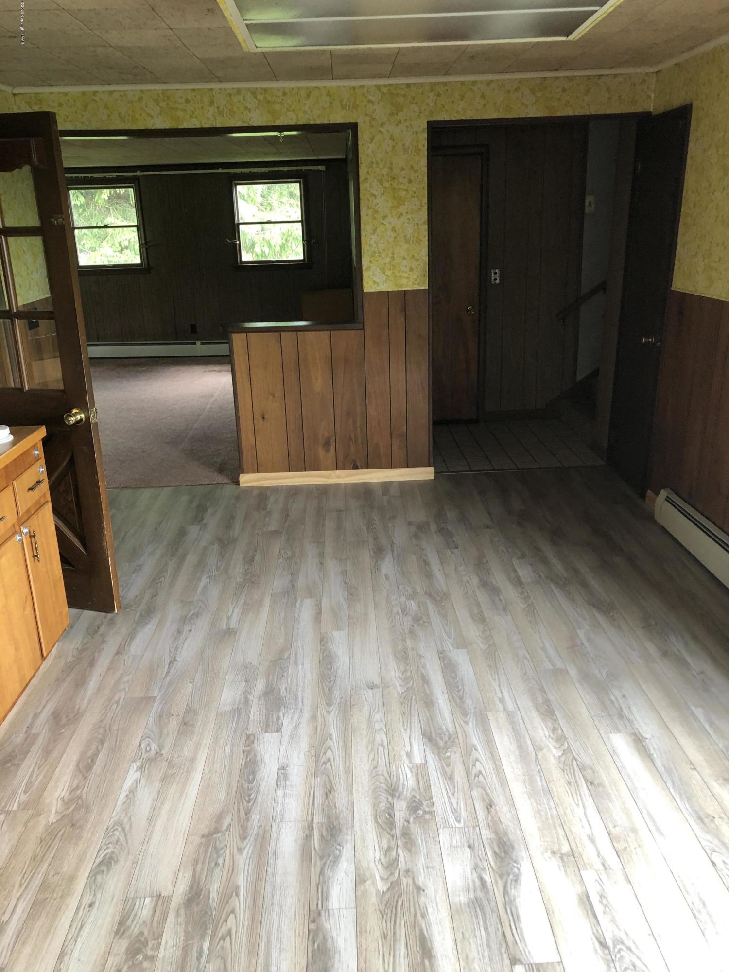 571 Spring Hill Road Moscow, PA 18444 - Photo 11 of 29 a view of empty room with wooden floor and fan