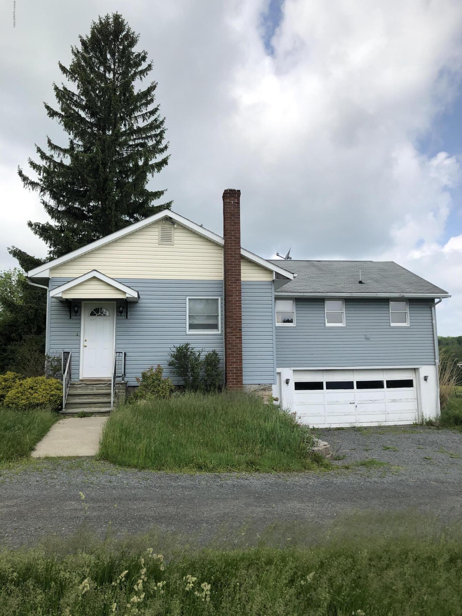 571 Spring Hill Road Moscow, PA 18444 - Photo 2 of 29 a front view of a house with a yard