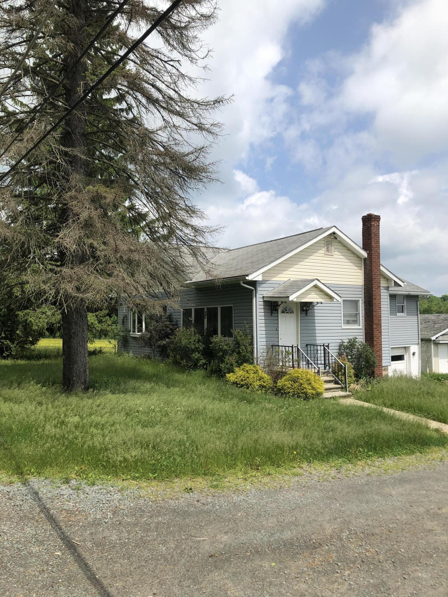 571 Spring Hill Road Moscow, PA 18444 - Photo 5 of 29 a front view of house with yard and green space