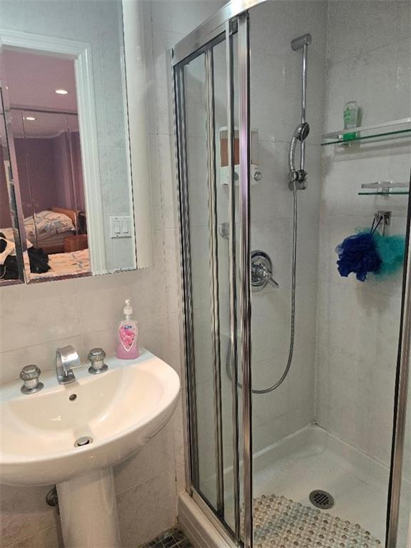 1625 Emmons Avenue, Unit 5D Brooklyn, NY 11235 - Photo 11 of 23 a bathroom with a shower sink and mirror
