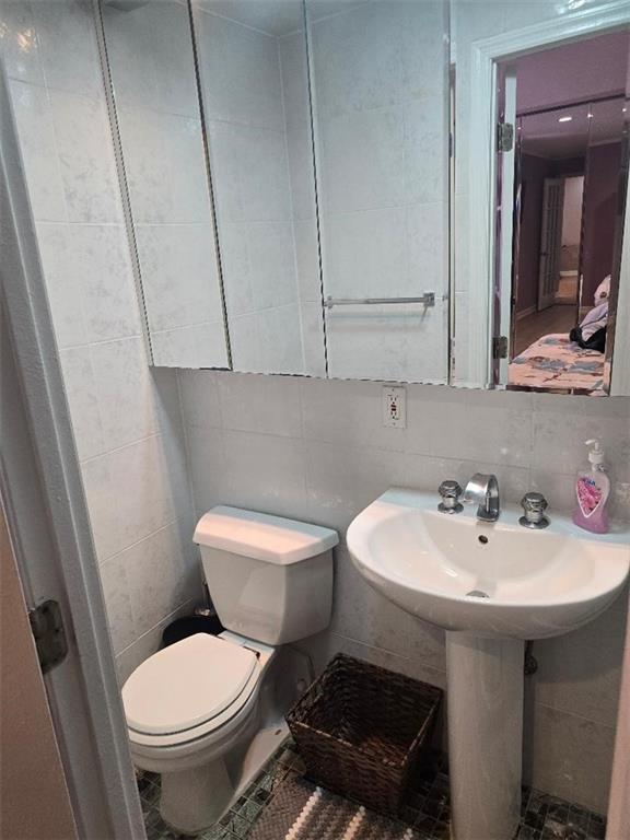 1625 Emmons Avenue, Unit 5D Brooklyn, NY 11235 - Photo 12 of 23 a bathroom with a sink a toilet and mirror