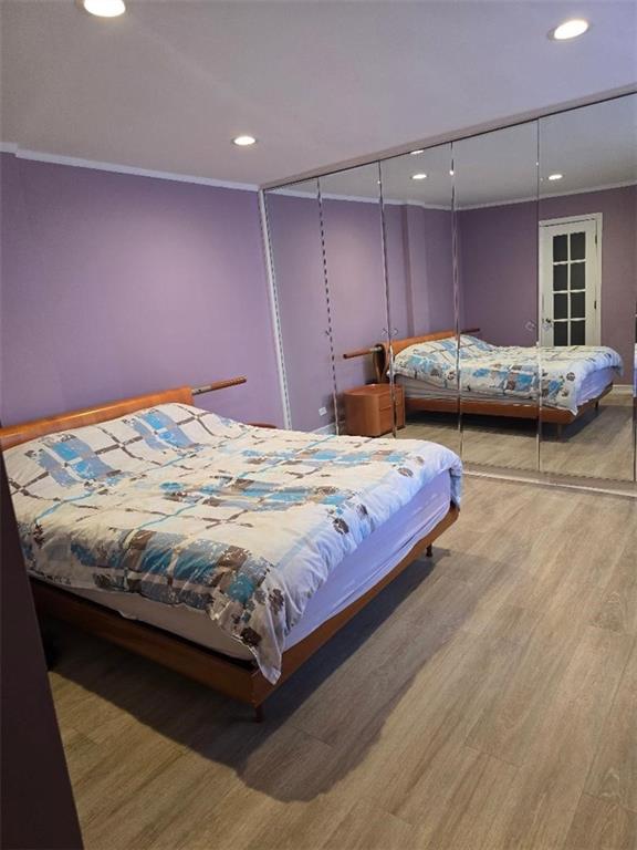 1625 Emmons Avenue, Unit 5D Brooklyn, NY 11235 - Photo 13 of 23 a spacious bedroom with a bed and a dresser