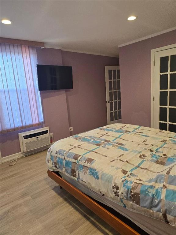 1625 Emmons Avenue, Unit 5D Brooklyn, NY 11235 - Photo 14 of 23 a bedroom with a bed and a flat screen tv