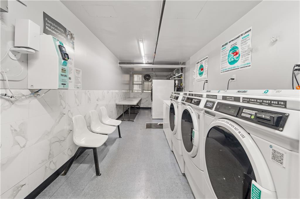 1625 Emmons Avenue, Unit 5D Brooklyn, NY 11235 - Photo 18 of 23 a view of washer and dryer with kitchen in the background
