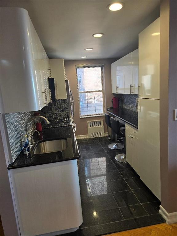 1625 Emmons Avenue, Unit 5D Brooklyn, NY 11235 - Photo 4 of 23 a kitchen with granite countertop a stove and a refrigerator