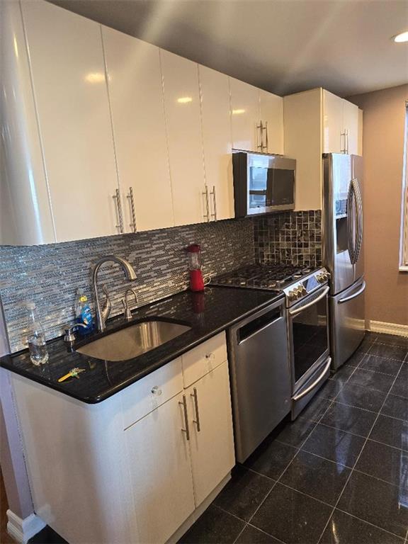 1625 Emmons Avenue, Unit 5D Brooklyn, NY 11235 - Photo 5 of 23 a kitchen with granite countertop a sink and a stove