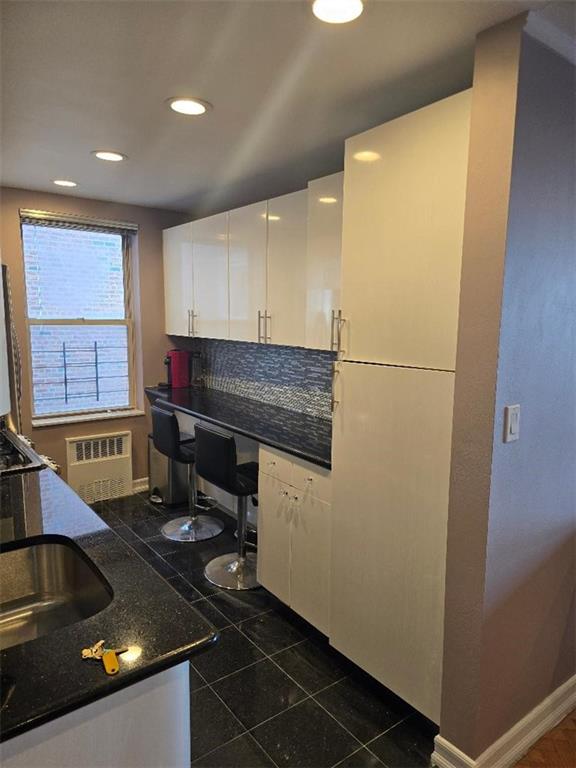 1625 Emmons Avenue, Unit 5D Brooklyn, NY 11235 - Photo 6 of 23 a kitchen with a sink appliances and cabinets