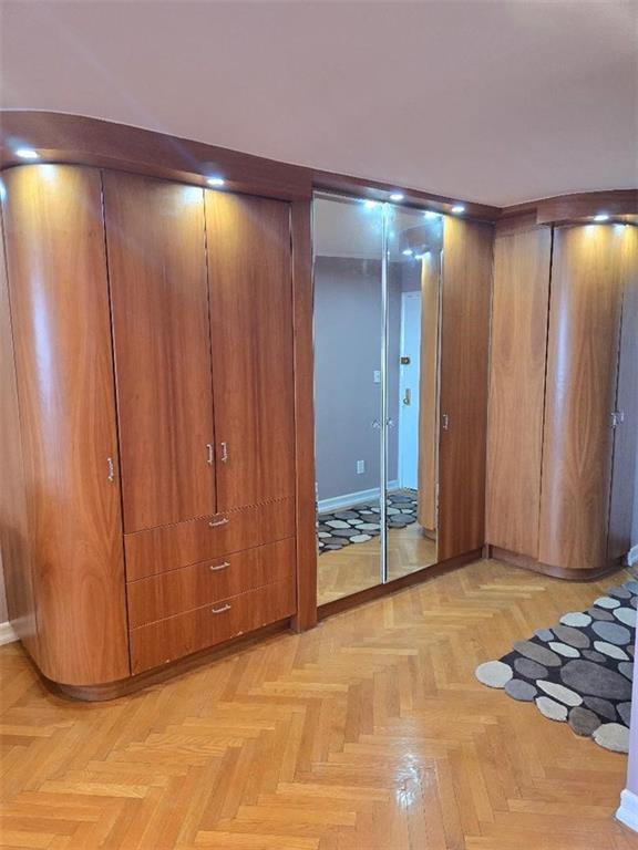 1625 Emmons Avenue, Unit 5D Brooklyn, NY 11235 - Photo 9 of 23 a view of an empty room with wooden walls