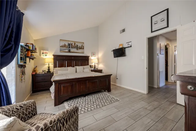 a bedroom with a bed and a window