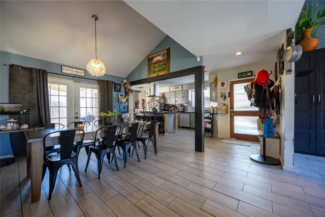 a view of a patio with table and chairs under an umbrella with wooden floor