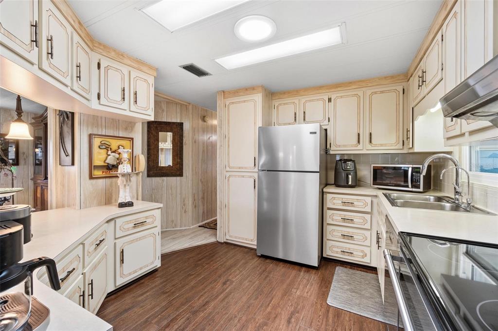 12501 Ulmerton Road, Unit 110 Largo, FL 33774 - Photo 11 of 29 a kitchen with stainless steel appliances a refrigerator sink and cabinets