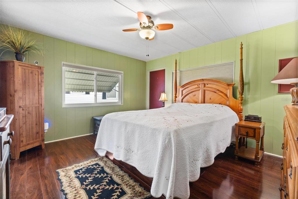 12501 Ulmerton Road, Unit 110 Largo, FL 33774 - Photo 13 of 29 a bedroom with a bed and a chandelier