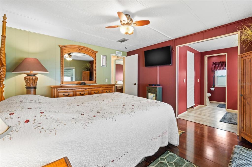 12501 Ulmerton Road, Unit 110 Largo, FL 33774 - Photo 14 of 29 a bedroom with a bed and a chandelier