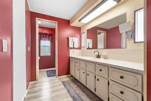 a spacious bathroom with double vanity and mirrors
