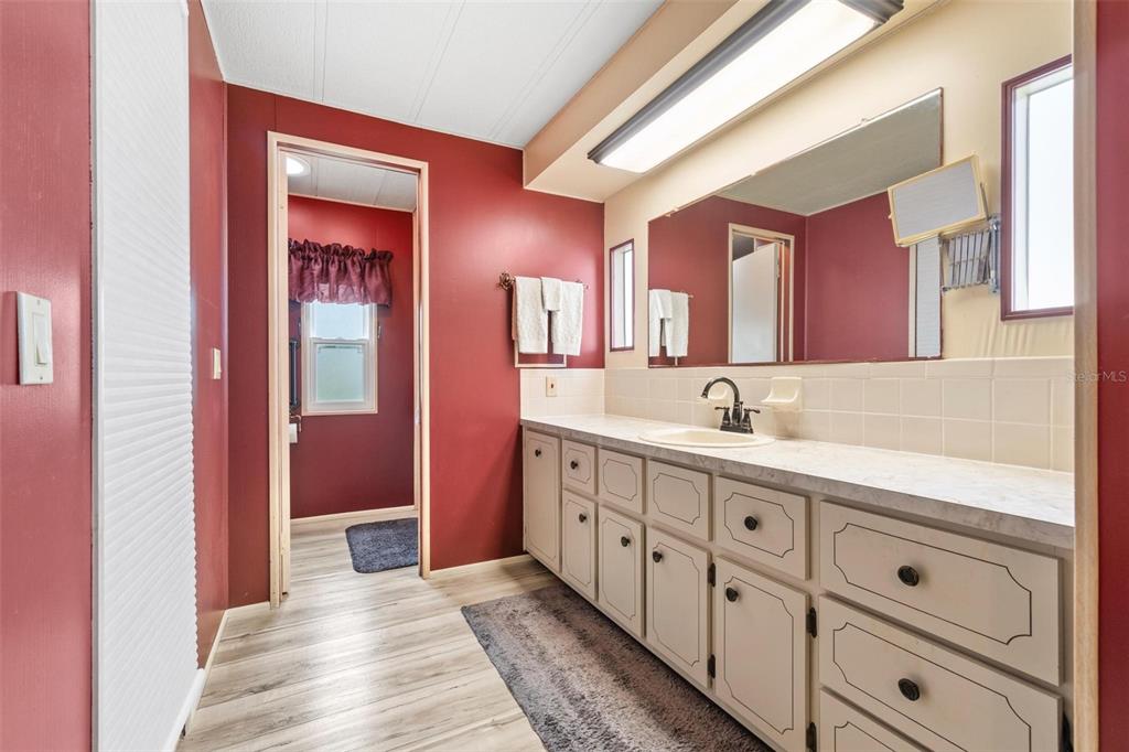 12501 Ulmerton Road, Unit 110 Largo, FL 33774 - Photo 17 of 29 a spacious bathroom with double vanity and mirrors