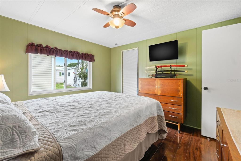 12501 Ulmerton Road, Unit 110 Largo, FL 33774 - Photo 19 of 29 a bedroom with a bed and a flat screen tv