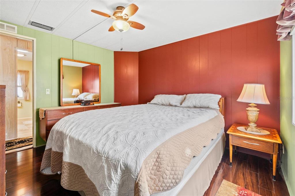 12501 Ulmerton Road, Unit 110 Largo, FL 33774 - Photo 20 of 29 a bedroom with a bed and a chandelier