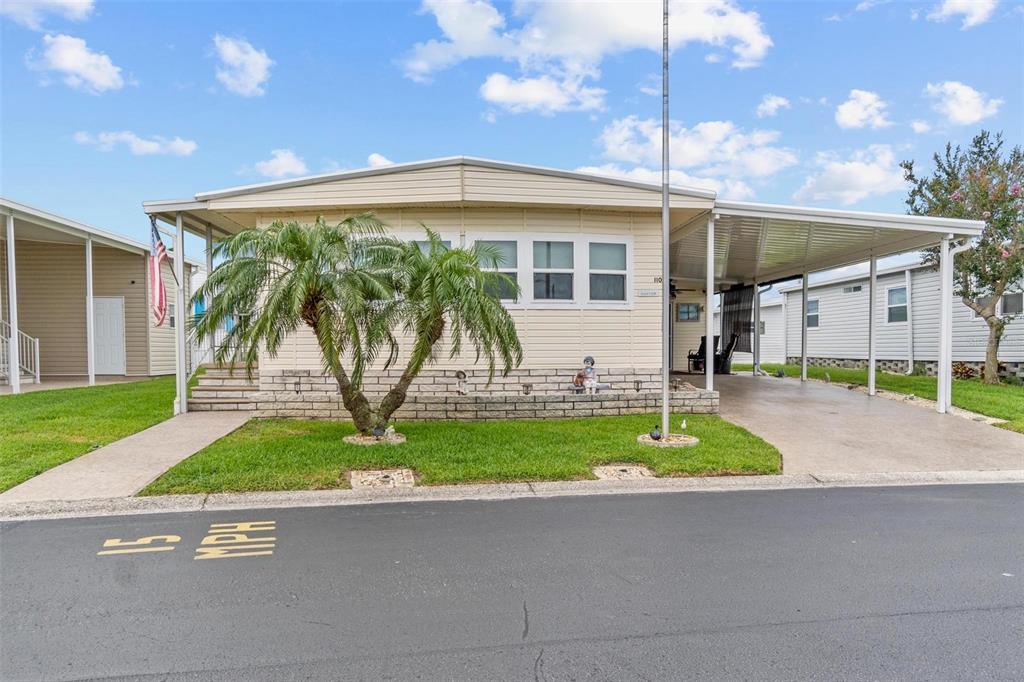 12501 Ulmerton Road, Unit 110 Largo, FL 33774 - Photo 2 of 29 a front view of a house with garden