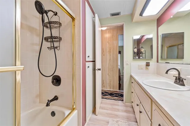 a bathroom with a tub sink and mirror