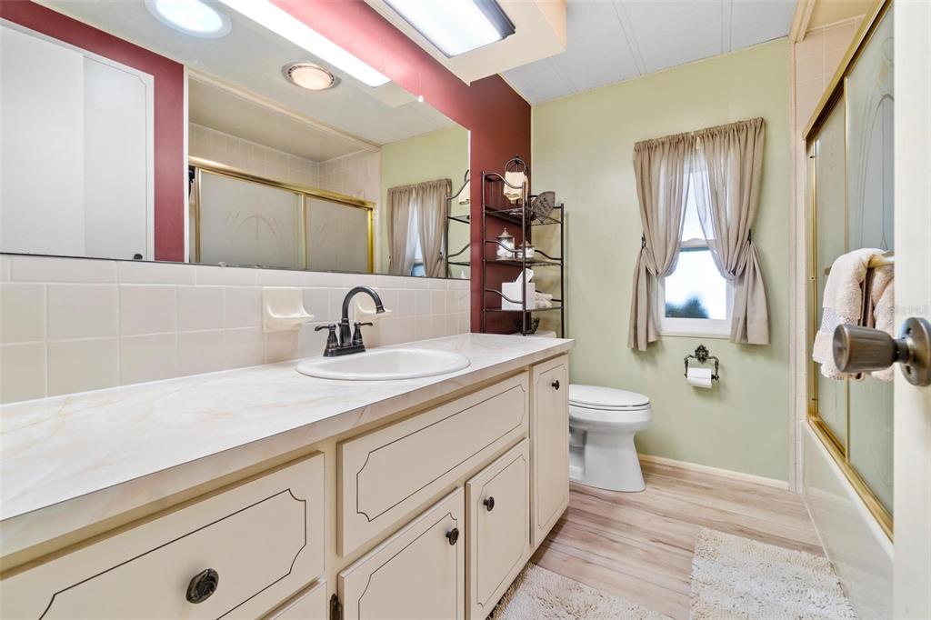 12501 Ulmerton Road, Unit 110 Largo, FL 33774 - Photo 22 of 29 a bathroom with a sink double vanity and a toilet