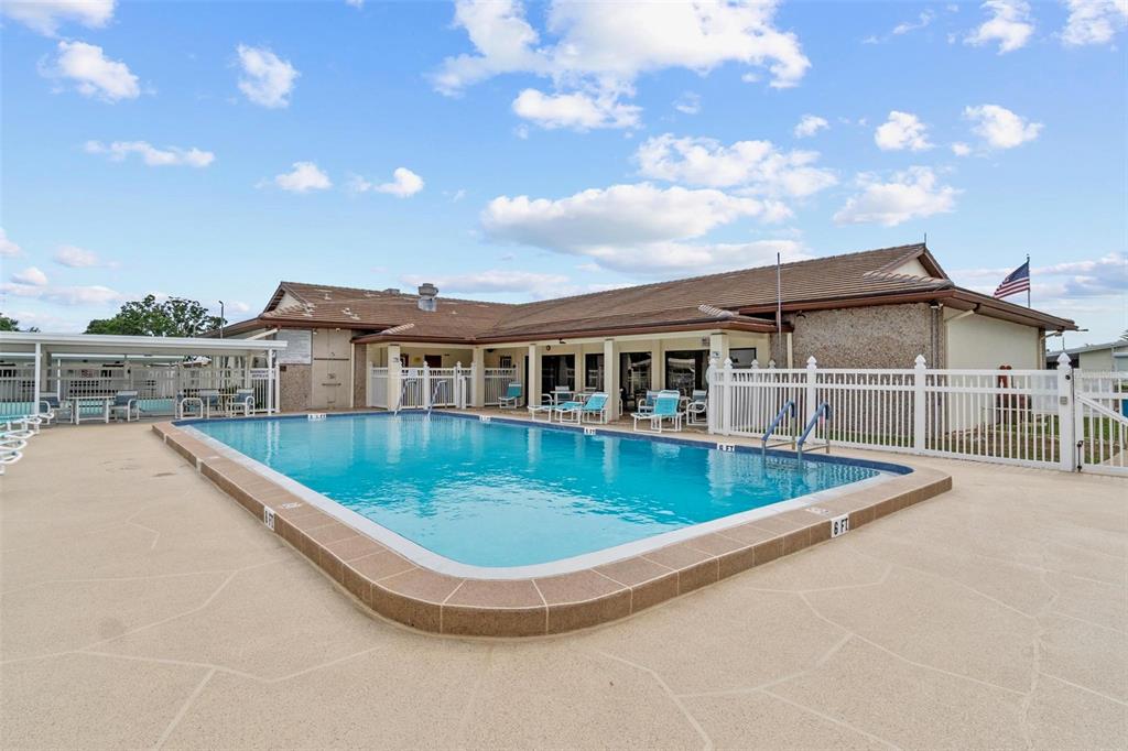 12501 Ulmerton Road, Unit 110 Largo, FL 33774 - Photo 28 of 29 a view of a house with pool and chairs
