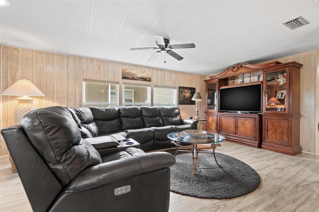 12501 Ulmerton Road, Unit 110 Largo, FL 33774 - Photo 7 of 29 a living room with furniture and a flat screen tv