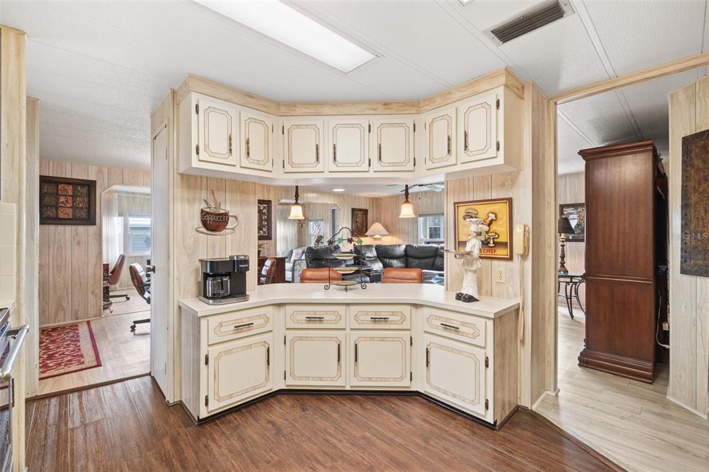 12501 Ulmerton Road, Unit 110 Largo, FL 33774 - Photo 9 of 29 a kitchen with white cabinets and stainless steel appliances