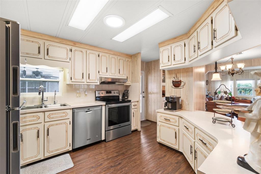 12501 Ulmerton Road, Unit 110 Largo, FL 33774 - Photo 10 of 29 a kitchen with stainless steel appliances white cabinets and a sink