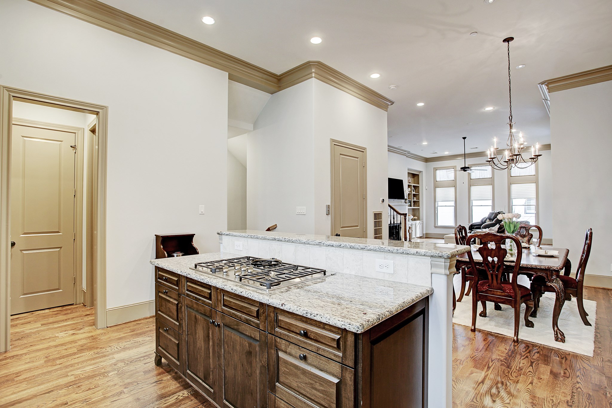 1307 Rosedale Street Houston, TX 77004 - Photo 15 of 32 a kitchen with stainless steel appliances granite countertop a stove refrigerator a dining table and chairs with wooden floor