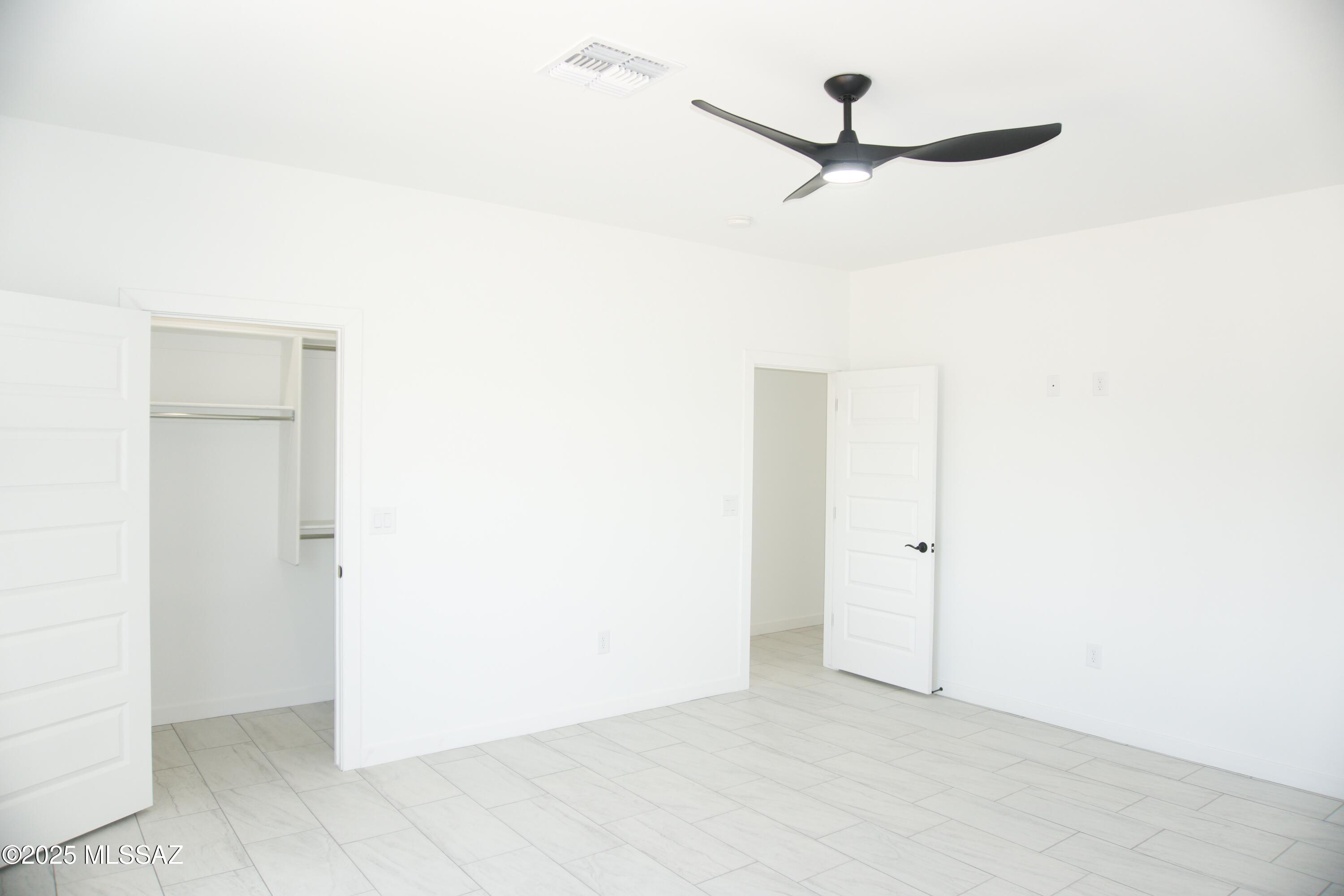126 Alemania Court Rio Rico, AZ 85648 - Photo 28 of 31 a view of a room with a ceiling fan and closet