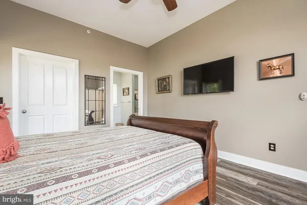 a bedroom with a bed and a flat screen tv