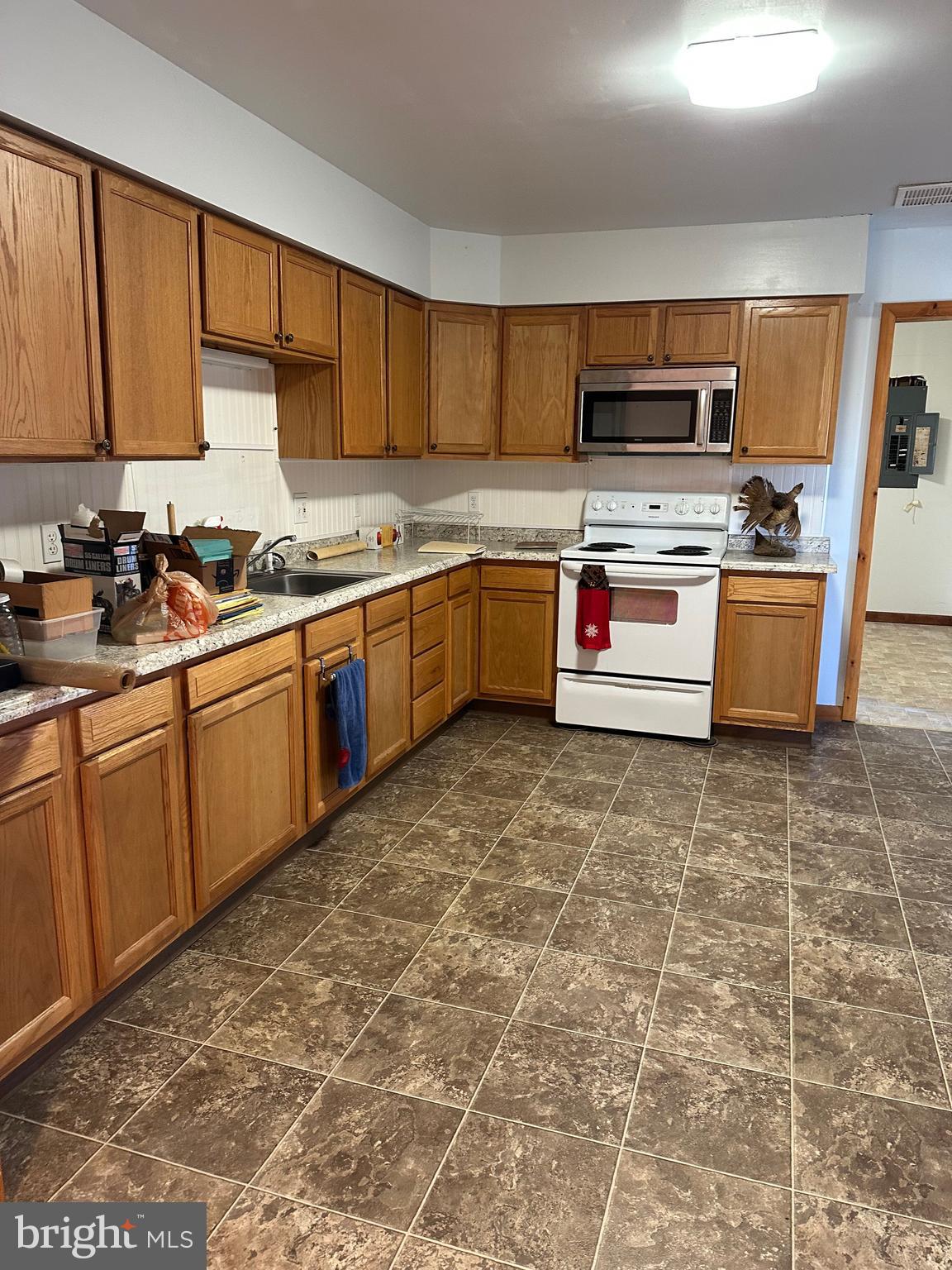 266 Jackson Road Quarryville, PA 17566 - Photo 15 of 32 a kitchen with stainless steel appliances granite countertop a stove sink and cabinets