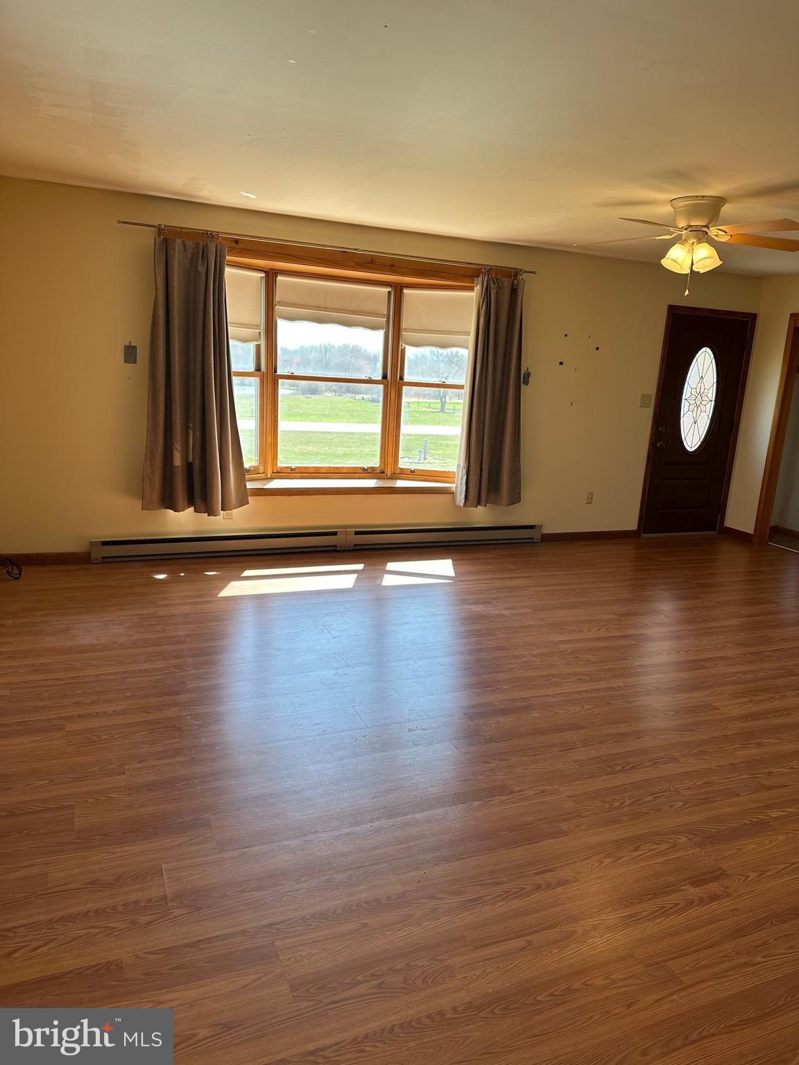 266 Jackson Road Quarryville, PA 17566 - Photo 17 of 32 a view of an empty room with wooden floor and a window