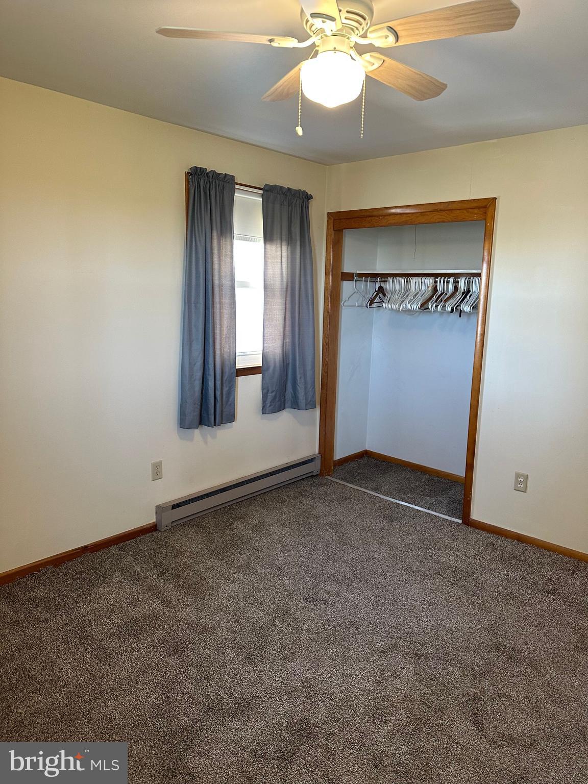 266 Jackson Road Quarryville, PA 17566 - Photo 23 of 32 an empty room with a chandelier fan and a large window