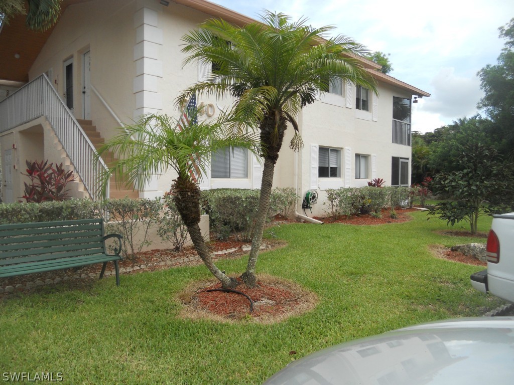 8140 County Road, Unit 102 Fort Myers, FL 33919 - Photo 12 of 16 a front view of a house with garden