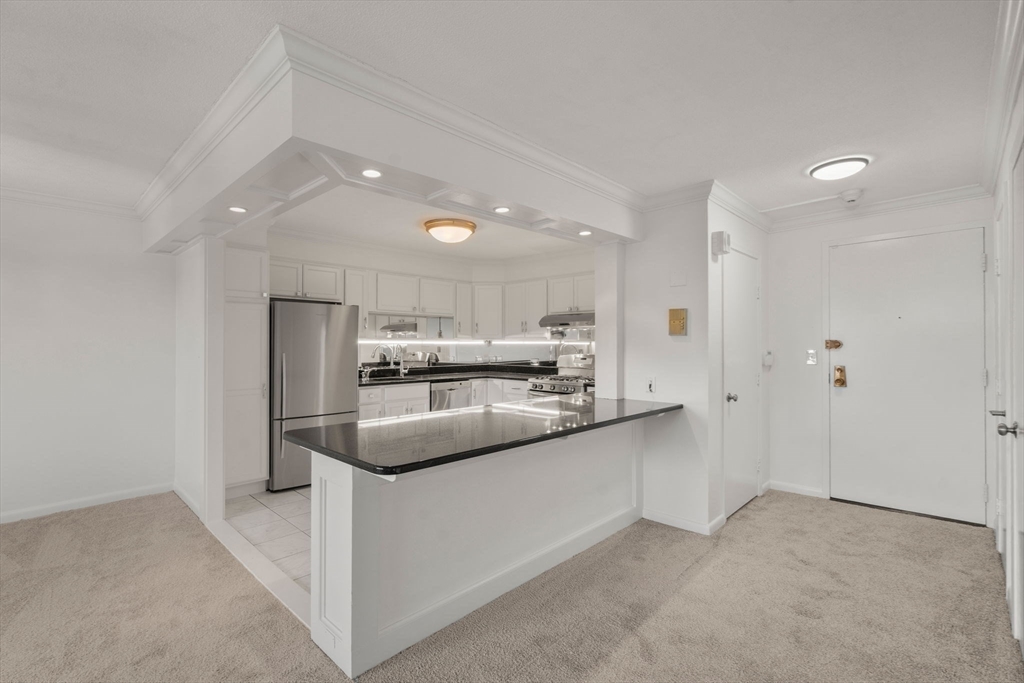 280 Boylston Street, Unit 905 Newton, MA 02467 - Photo 7 of 22 a kitchen with stainless steel appliances a sink stove and refrigerator