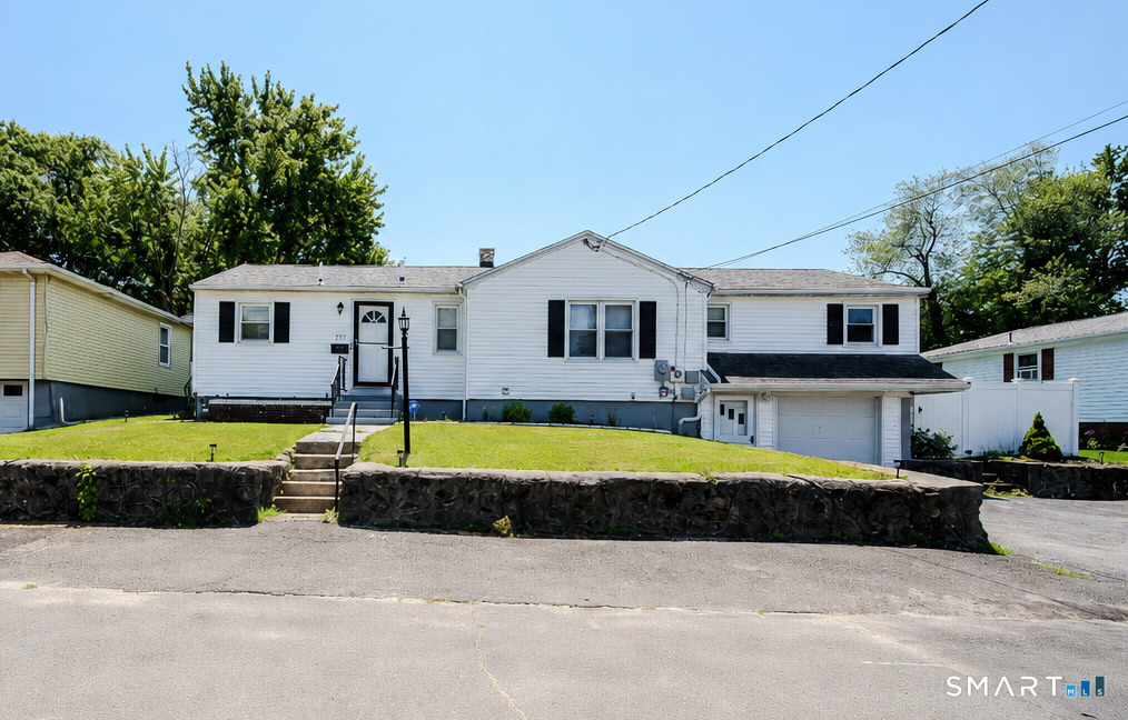 869 Washington Ave Extension Waterbury, CT 06708 - Photo 1 of 23 a front view of a house with swimming pool and porch