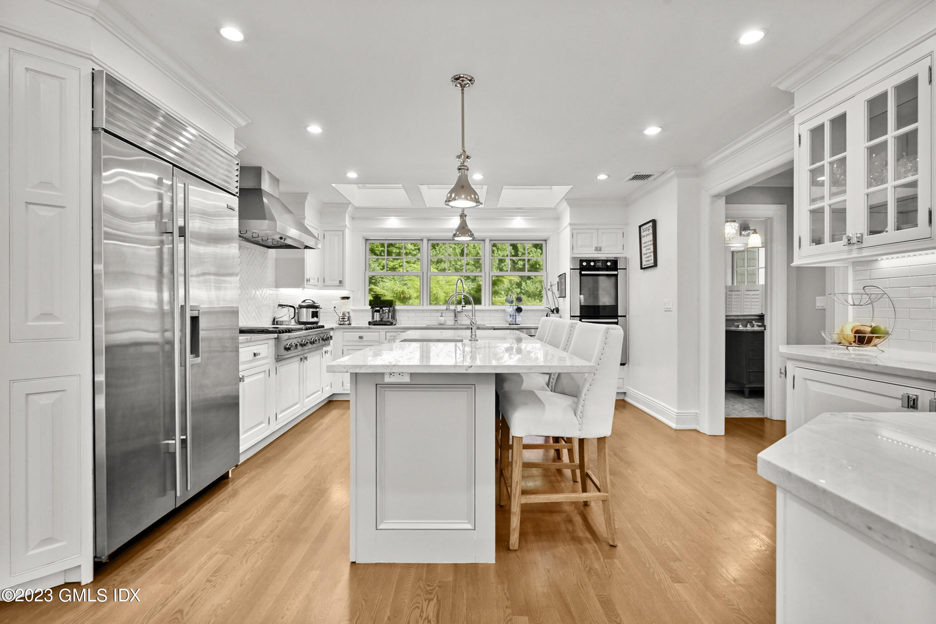 36 Evergreen Road Greenwich, CT 06830 - Photo 11 of 42 a kitchen with stainless steel appliances granite countertop a refrigerator a sink dishwasher a stove and white cabinets with wooden floor