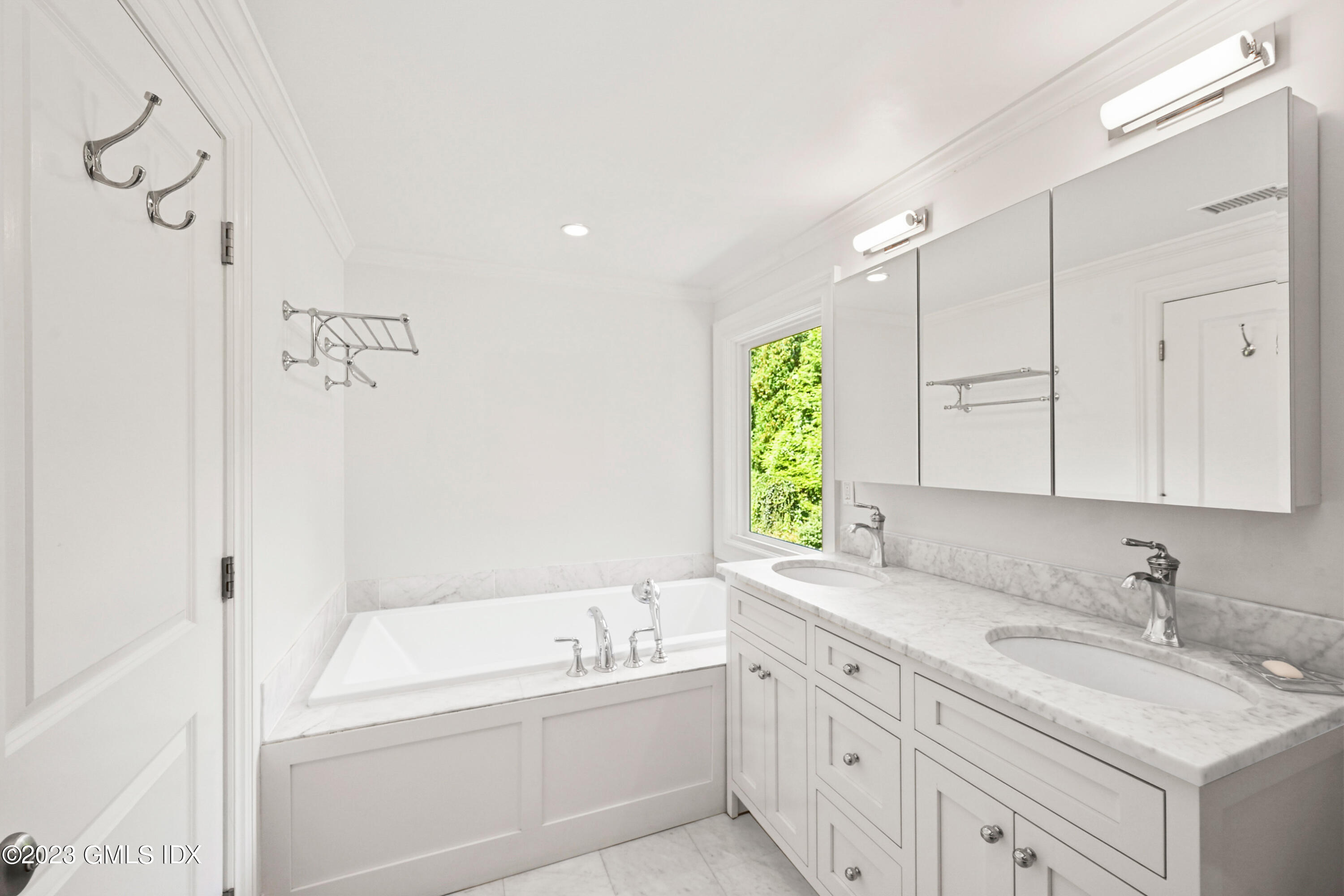 36 Evergreen Road Greenwich, CT 06830 - Photo 22 of 42 a bathroom with a granite countertop sink mirror bathtub and next to a window