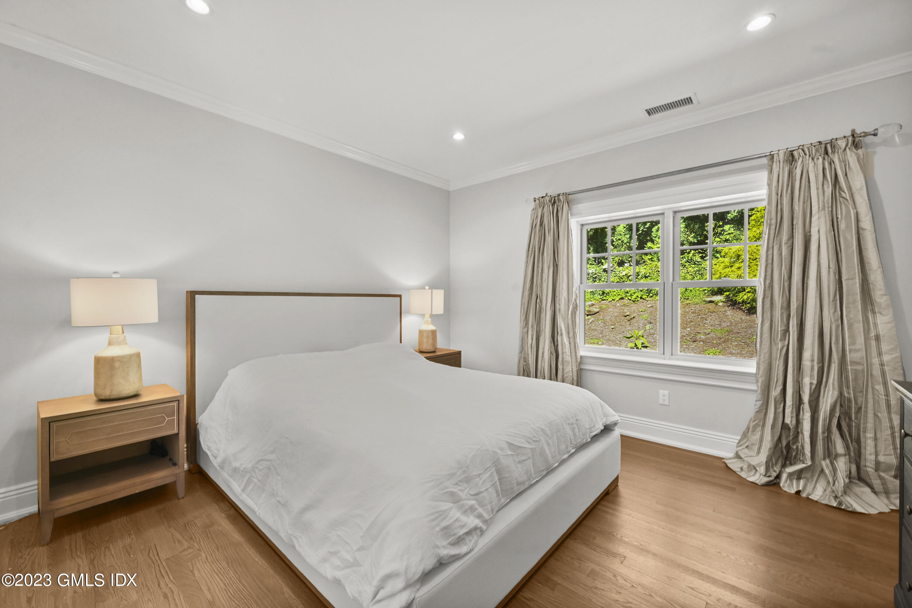 36 Evergreen Road Greenwich, CT 06830 - Photo 27 of 42 a bedroom with a bed and a night stand