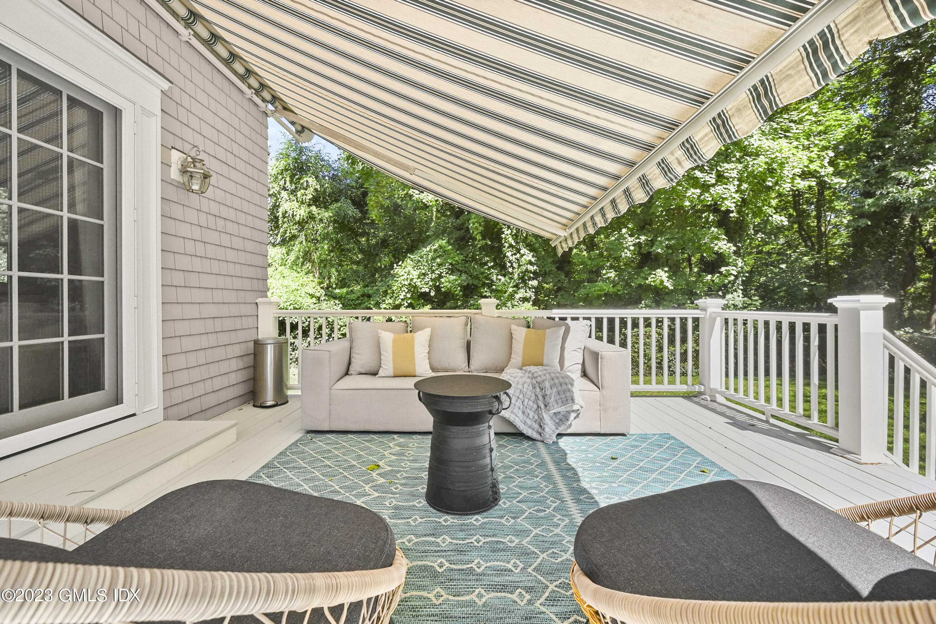 36 Evergreen Road Greenwich, CT 06830 - Photo 31 of 42 a view of a chair and tables back yard of the house