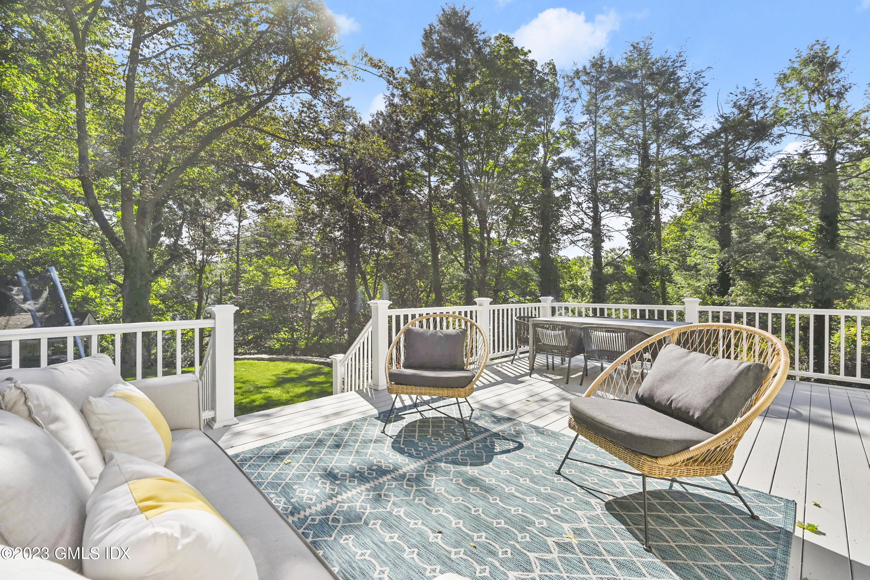 36 Evergreen Road Greenwich, CT 06830 - Photo 32 of 42 a view of a chair and tables the yard