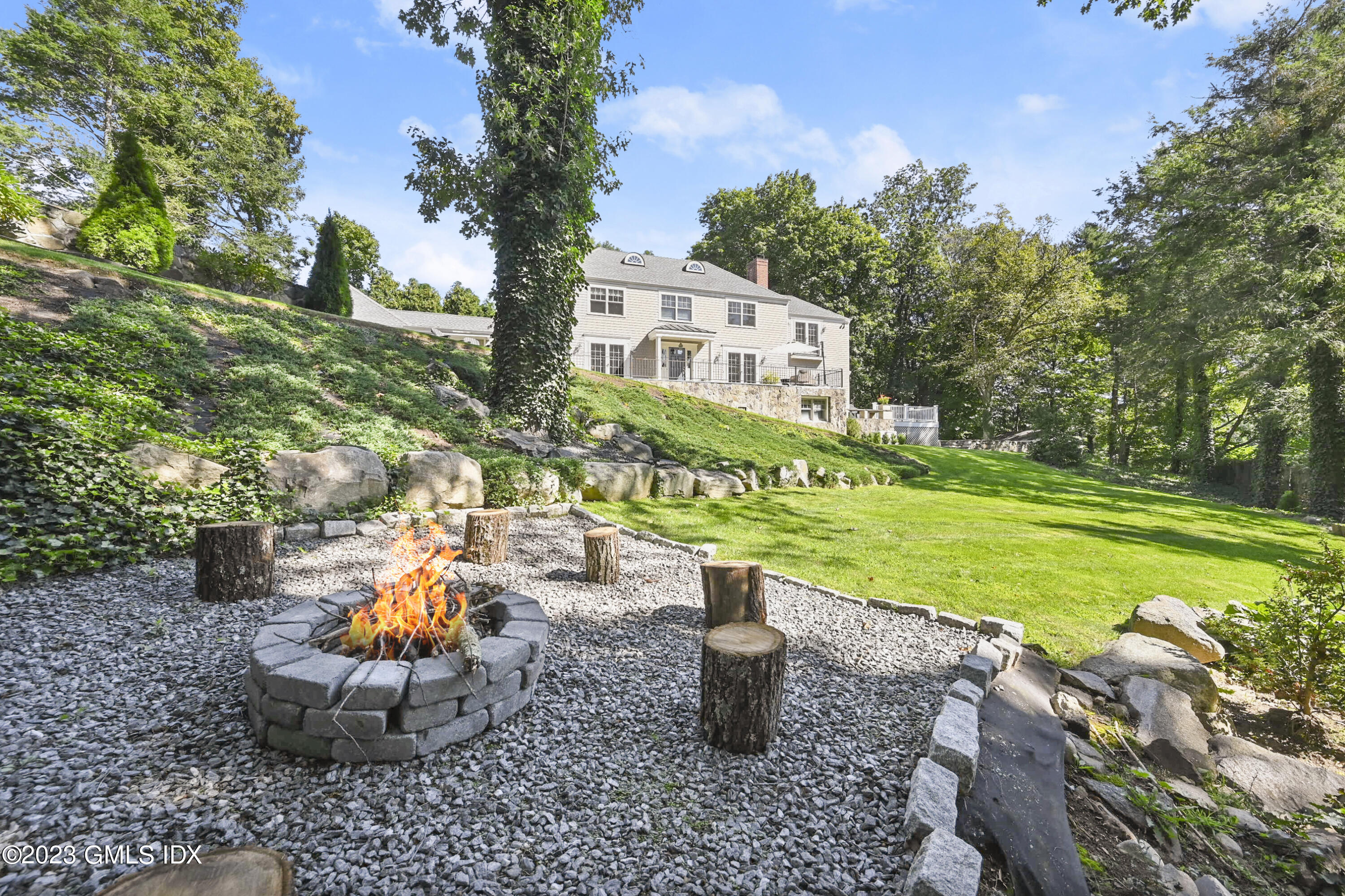 36 Evergreen Road Greenwich, CT 06830 - Photo 37 of 42 a view of a chairs and table in the garden
